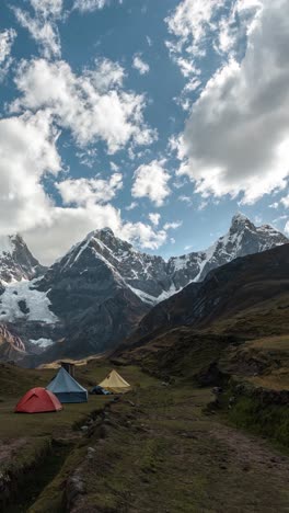 vertical 4k timelapse, base camp tents under huayhuash mountain, andes, peru