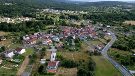 Parallax-around-city-center-of-rural-countryside-village-in-Spain,-aerial