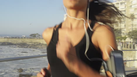 mixed race woman runner running on road