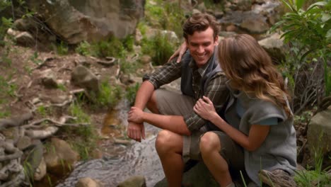 couple on a rock looking away