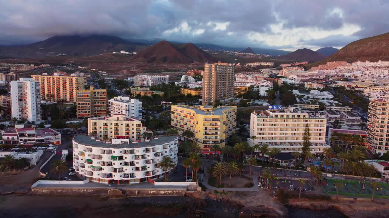 Establisher aerial of hotels facing vast beach in Los Cristianos, Tenerife