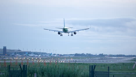 slow motion shot of airplane approaching landing lane, overcast cloudy day