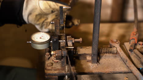 band saw band path bending table with micrometer in closeup on mechanic at work