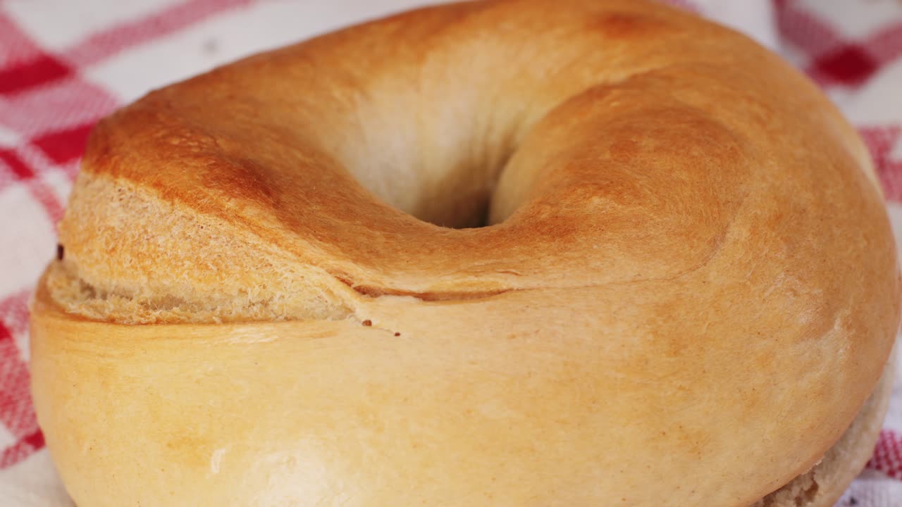 Bagel sandwich brunch, lunch plate of a bagel with smoked salmon and cream cheese and ham, close up morning cafe menu.