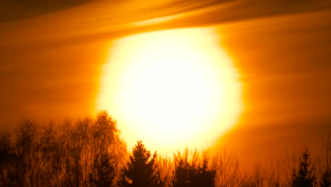 Apocalyptic-and-impressive-sun-during-sunset,-saturated-orange-sky,-Latvia