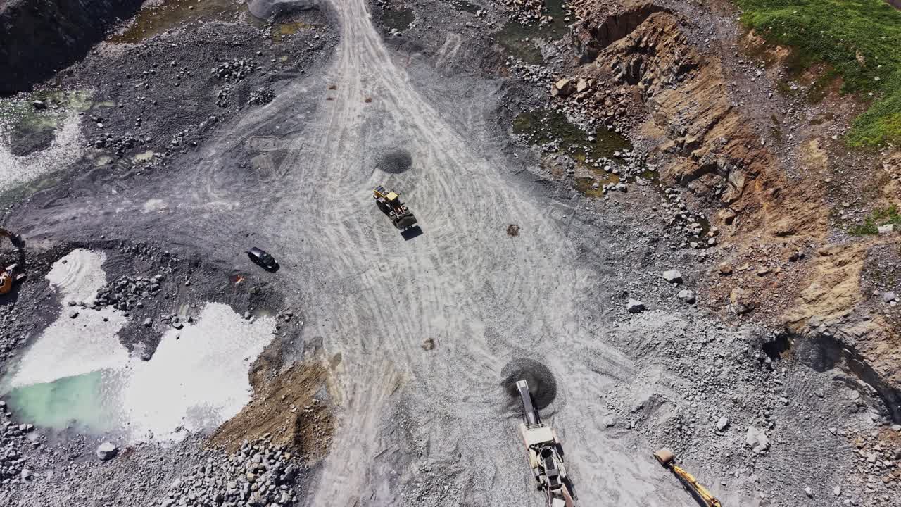 Aerial View of Heavy Machinery Working in a Large Quarry