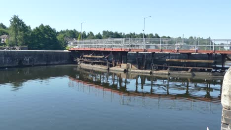 barrera de la vía fluvial de la puerta de bloqueo del canal británico bajo un cielo azul que refleja el agua