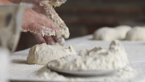 baker hands forming dough portions for baking georgian shotis puri