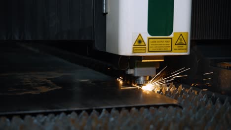 metal laser cutting machine. modern laser cutting of sheet metal parts using a computer. bright sparks from the installation