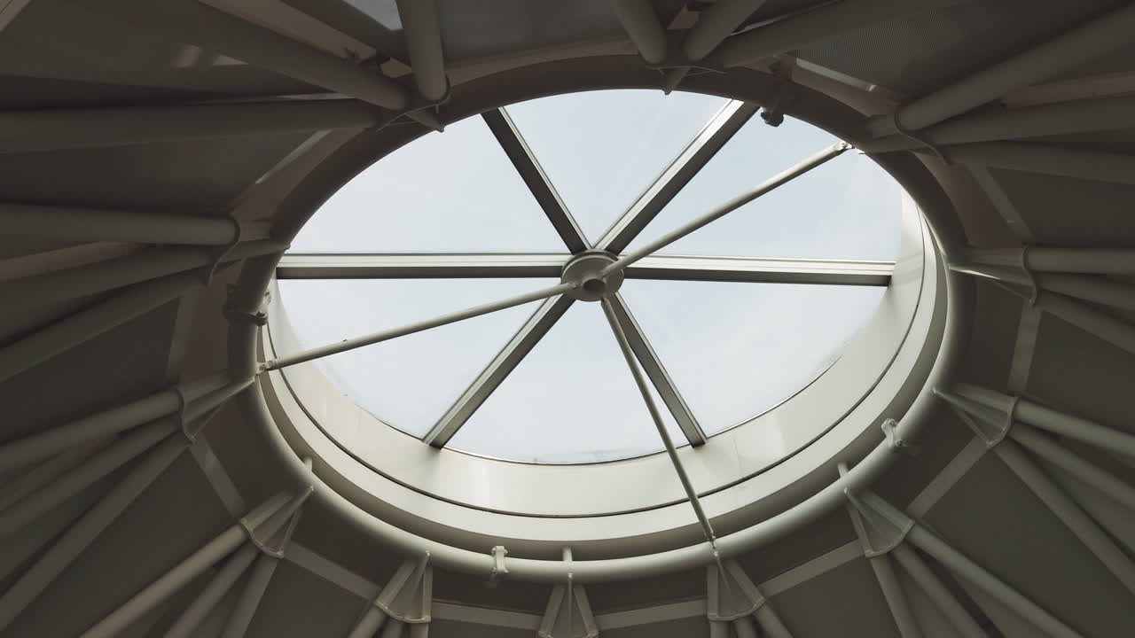 Top view on structural glass facade curving roof of office building modern and contemporary