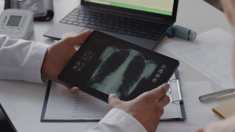 doctor reviewing chest x-ray on tablet