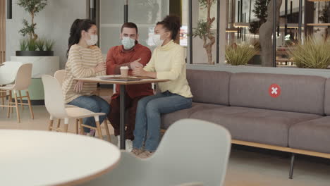 young colleagues having meeting in restaurant