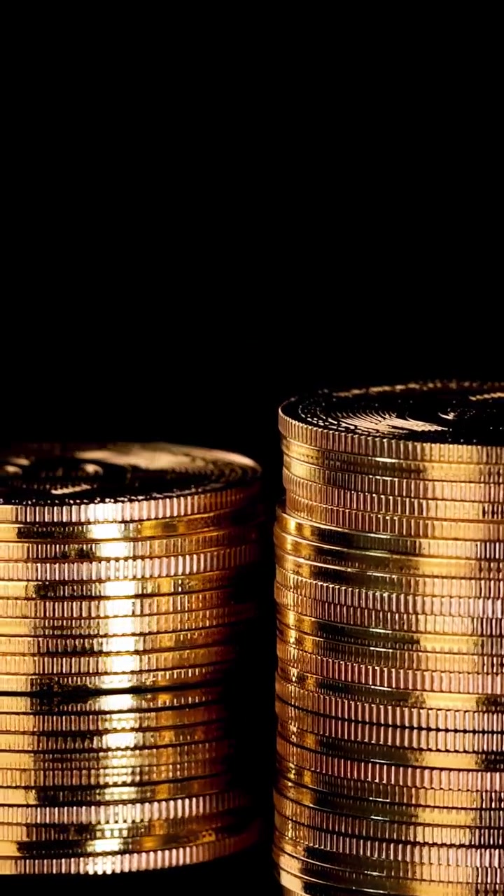 Shiny gold coins rotate in stacks, dramatic lighting, black background, smooth camera movement, macro view