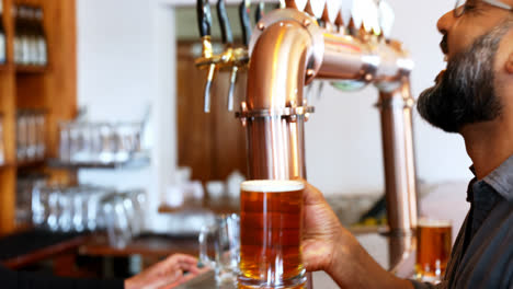 senior waitress serving beer to customer 4k