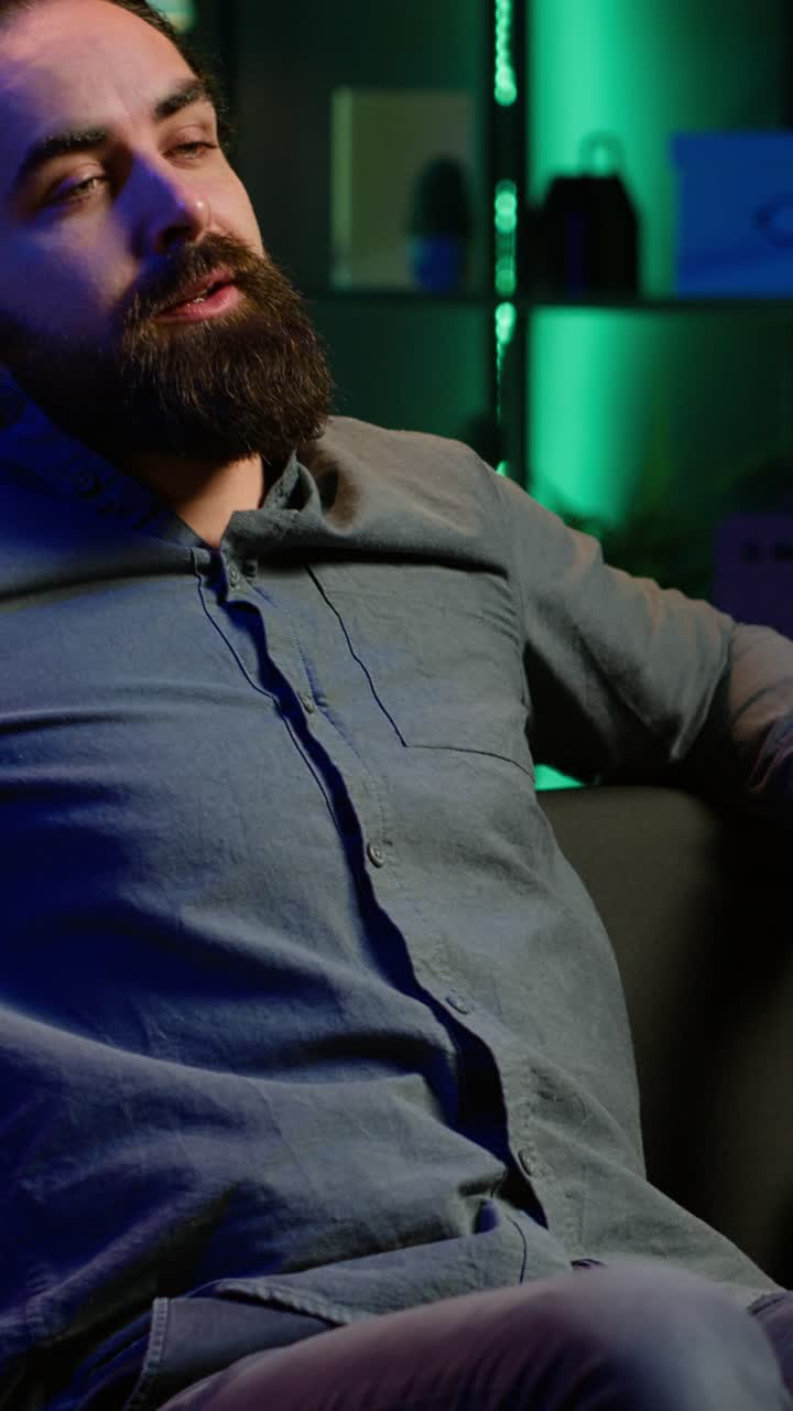 Vertical video Upset supporter watching sports match, shutting off TV in frustration