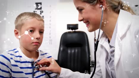 animation of molecules over smiling caucasian female doctor examining boy