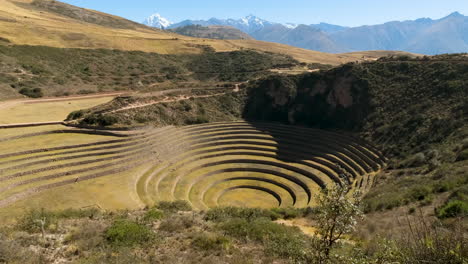 captures the incredible agricultural terraces of the moray archaeological site. a testament to ancient inca engineering, the unique concentric circles create a stunning, otherworldly landscape