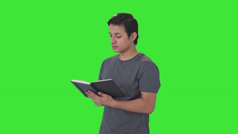 Happy-Indian-man-reading-a-book-Green-screen