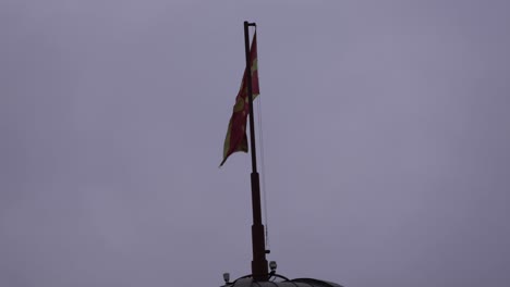 steady shot of the north macedonian flag at the capital city of skopje