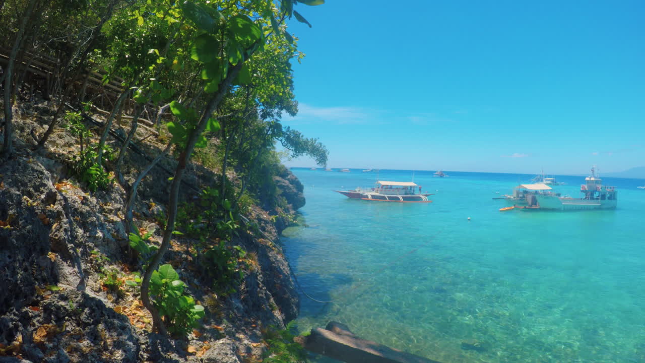 Beautiful View of a Cliff with Clear Ocean Water and Boats in the ...