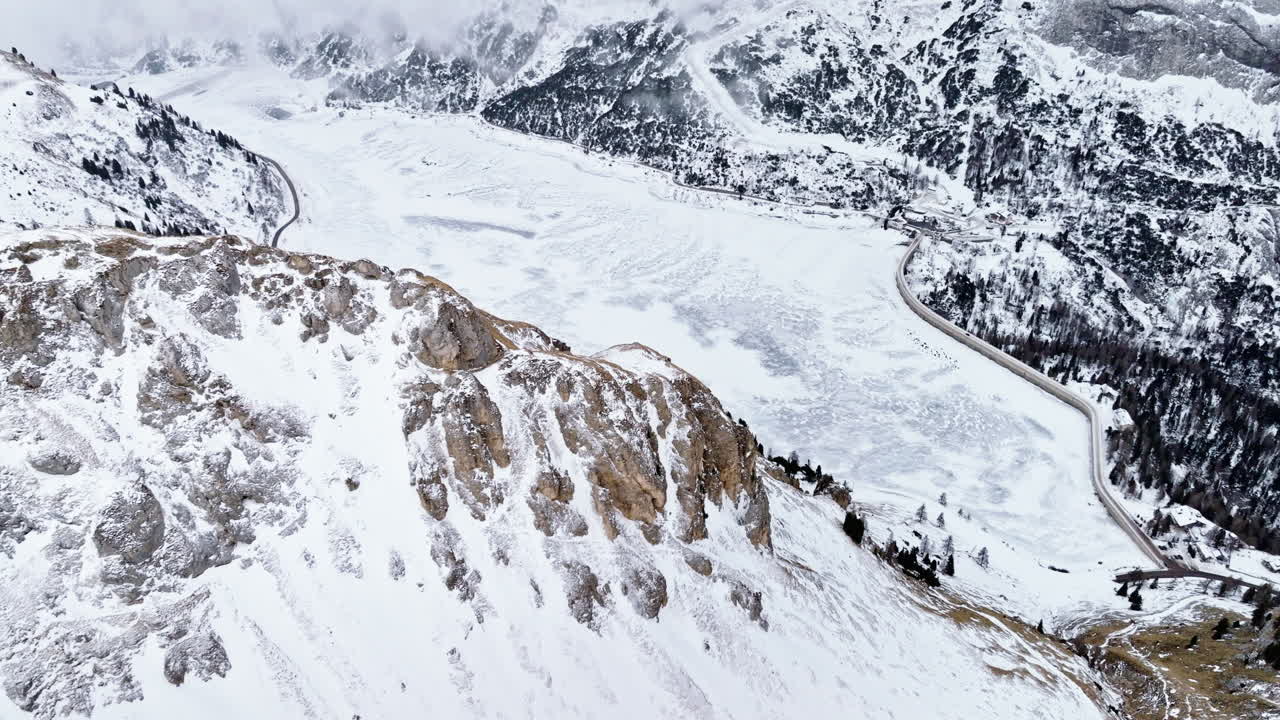 Aerial drone view of Portavescovo covered in snow, in Arabba, Italy