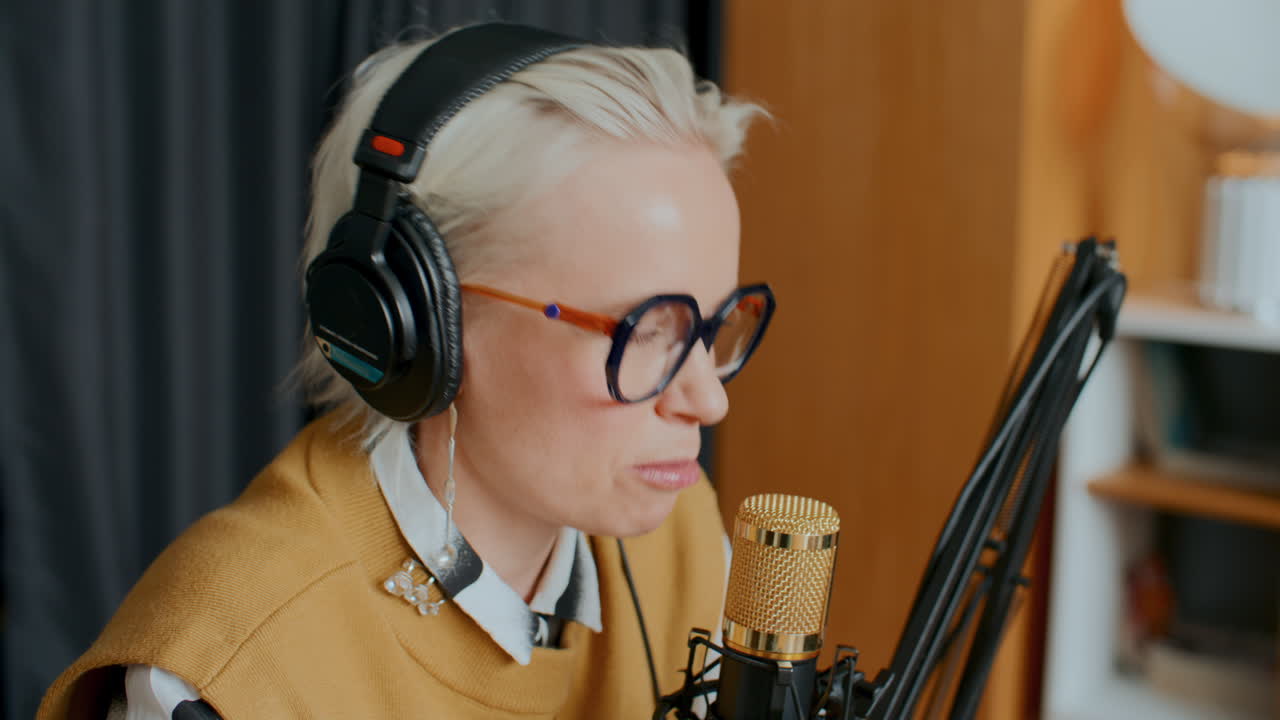 Female Blogger Talking in Mic and Smiling during Podcast Recording Session
