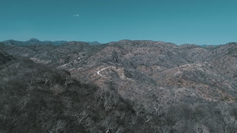 aerial shot of the sierra of sinaloa with a rural road