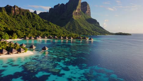 aerial video captures overwater bungalows and lush mountains video