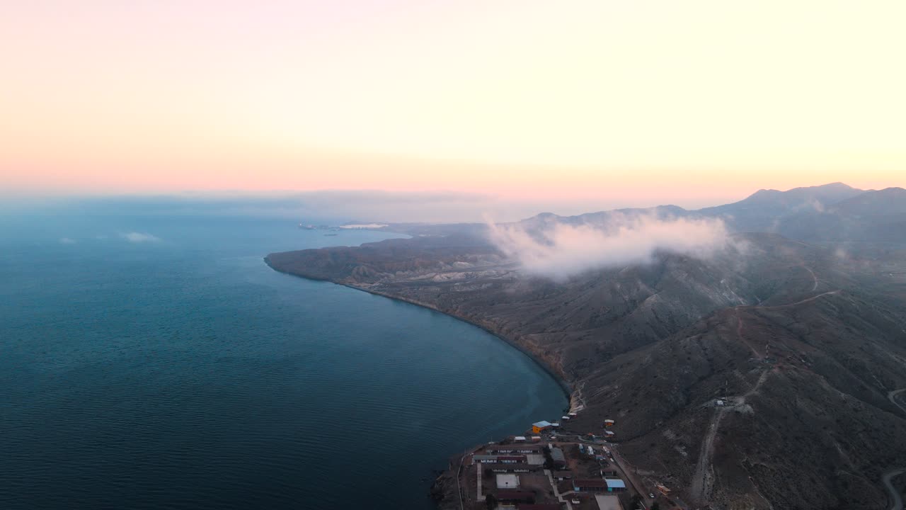 Aerial view of Cedros Island coastline at sunset, showcasing rocky terrain and ocean views