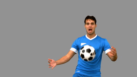 man controlling a football with his chest on grey screen