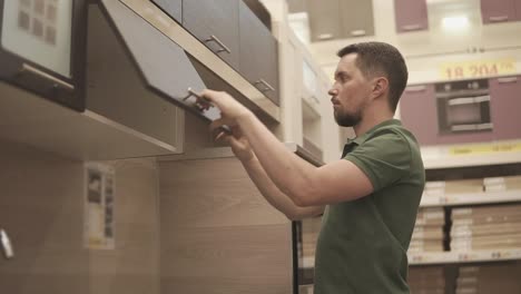 customer browsing and inspecting kitchen cabinets