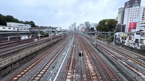 train tracks stretch through tokyo, with city buildings in the distance