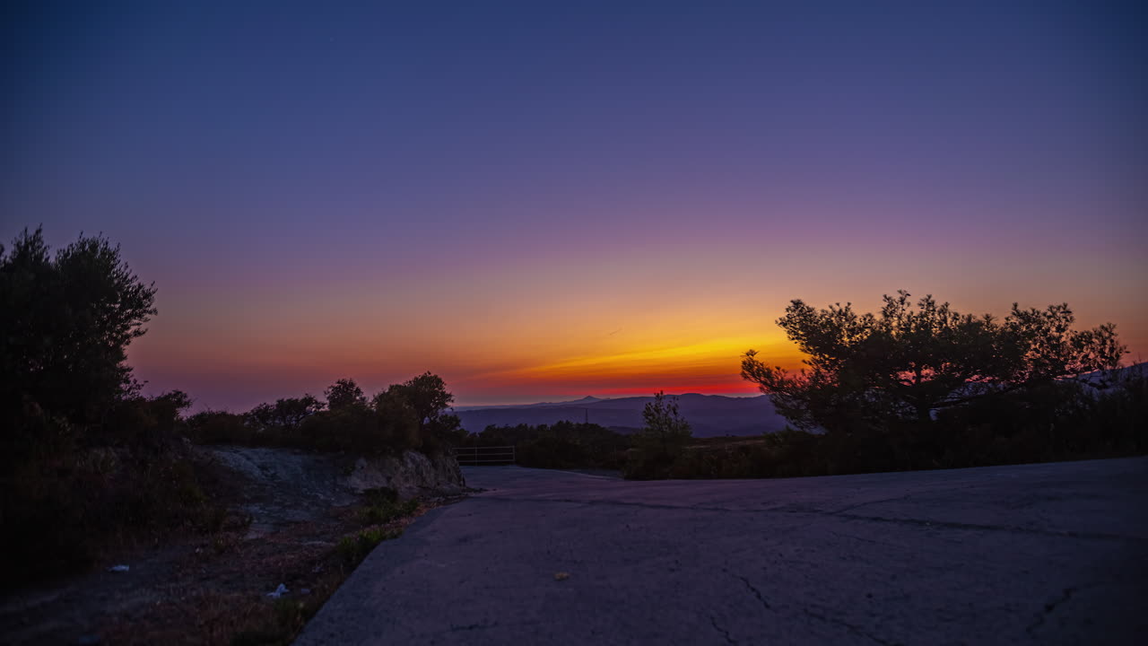 Dramatic Red Sunset Casting its Glow over a Serene Forest Glade - Breathtaking Timelapse of an Outdoor Evening Scene