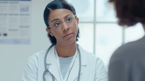 female practitioner talking with patient on consultation in clinic