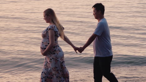 Multi-Ethnic-Couple---Asian-Man-And-His-Pregnant-Wife-Are-Walking-Along-The-Seashore