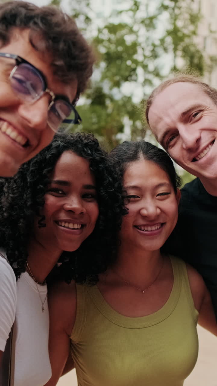 A group of young student people smiling, gesturing and looking at camera