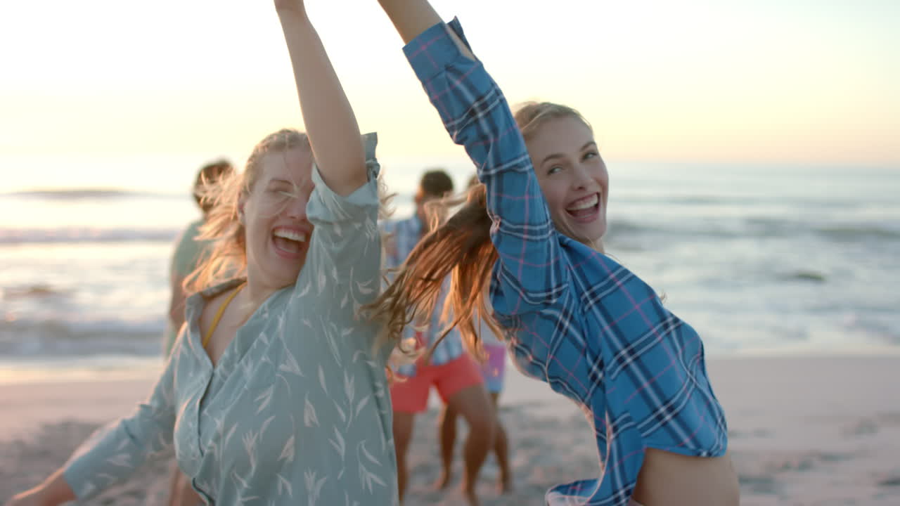 Caucasian couple enjoys a vibrant sunset at the beach at a party