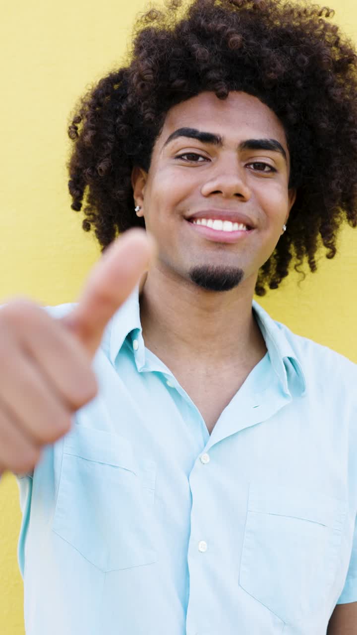 Portrait of a Smiling Man Giving Thumbs Up