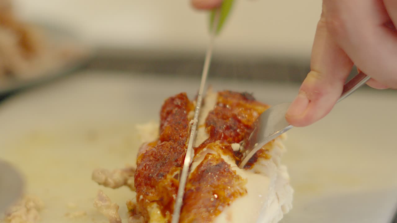 Chicken Fillet with Skin Being Spun and Carved Professionally with Hot Steam Rising. Lean Protein Roasted Meat Being Prepared After Cooking