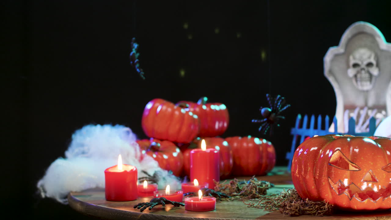 Halloween Decorations with Pumpkins, Candles, and a Skull