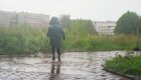 boy delights in splashing through puddles child embraces simple joys of rainy spring day and freedom