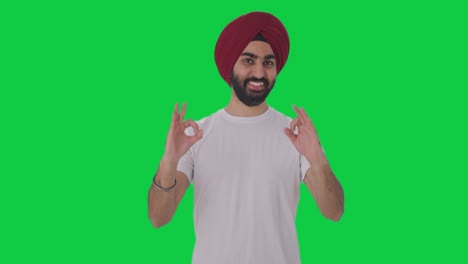 Happy-Sikh-Indian-man-showing-okay-sign-Green-screen