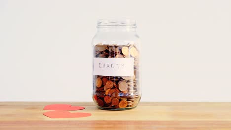 close-up of coins in bottle and heart