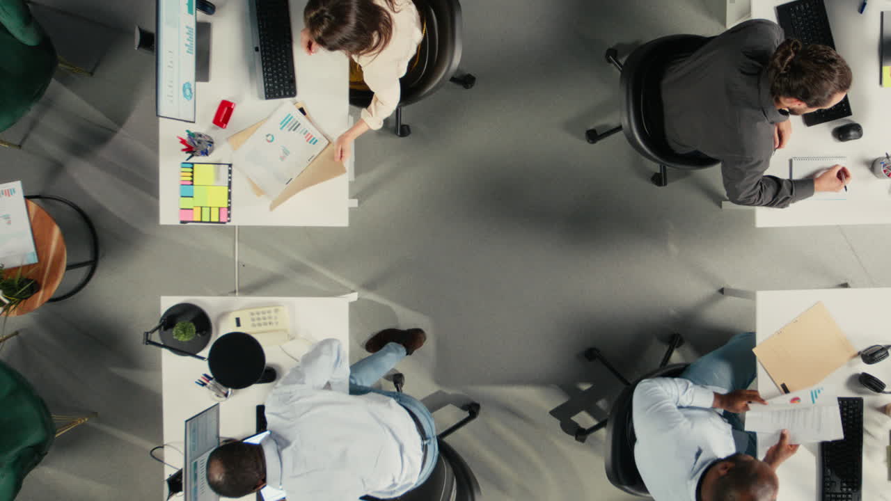 Vertical Video Top down view zoom out of manager leads colleagues through business intel