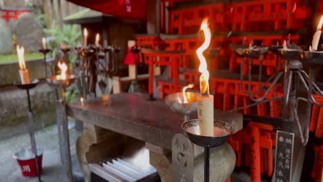 candles around the fushimi inari taisha shinto shrine in japan