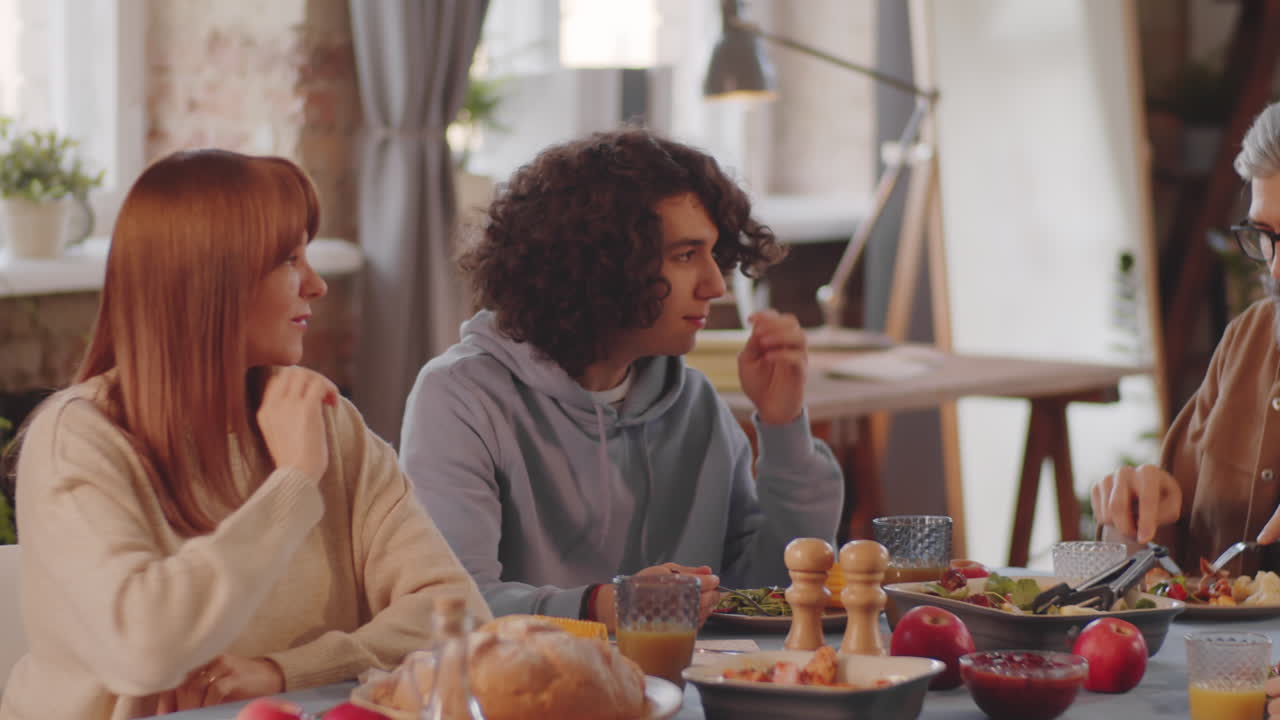 Family Talking while Having Dinner at Home