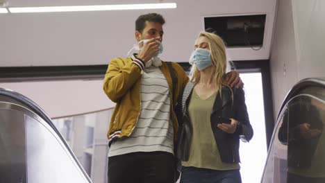 caucasian couple on the go wearing a coronavirus covid19 mask