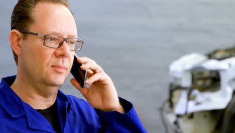 mechanic talking on mobile phone 4k