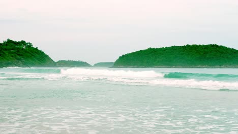 Ocean-waves-breaking-into-the-shore-on-the-beach-in-Phuket,-Thailand