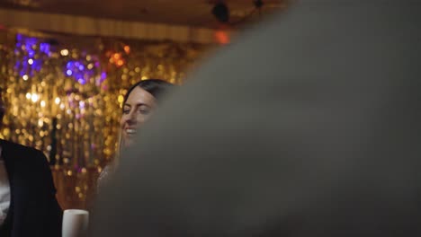 tracking shot of group of friends dancing together at a bar